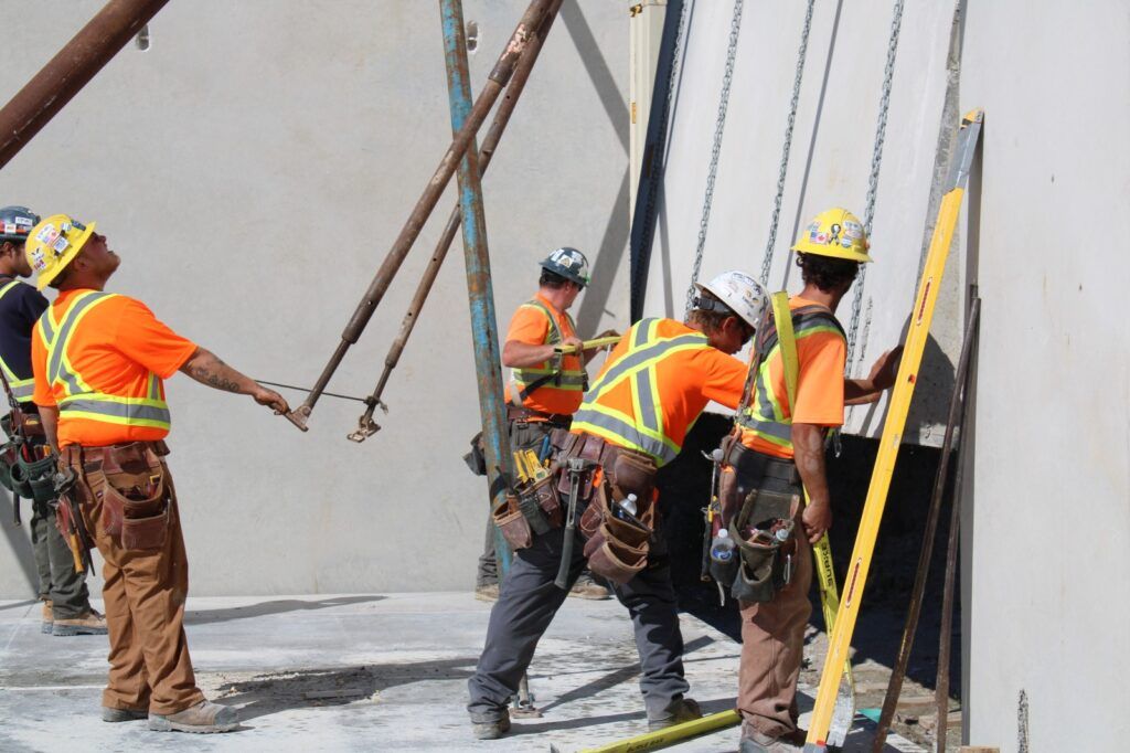 Labourers tilting tilt-up panel in place in Ontario, Canada.